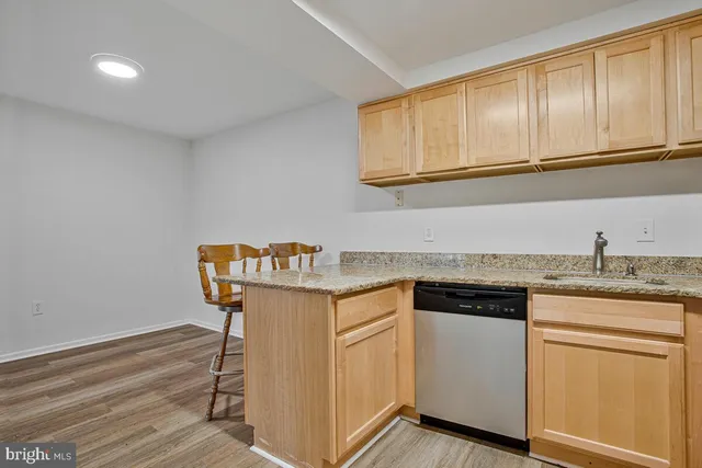 a kitchen with granite countertop cabinets sink and white appliances