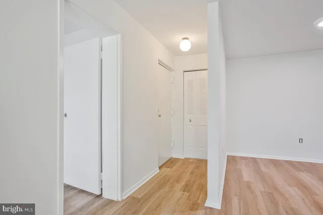 a view of hallway with wooden floor