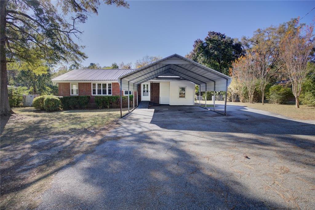 a front view of a house with a yard and trees