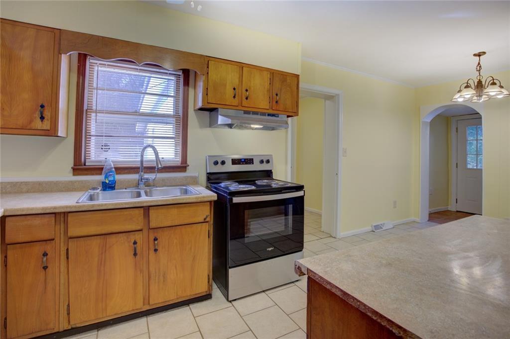 9174 Flat Shoals Road Southwest Covington, GA 30014 - Photo 13 of 25 a kitchen with cabinets and appliances