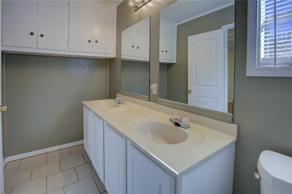 9174 Flat Shoals Road Southwest Covington, GA 30014 - Photo 17 of 25 a bathroom with a sink and a toilet