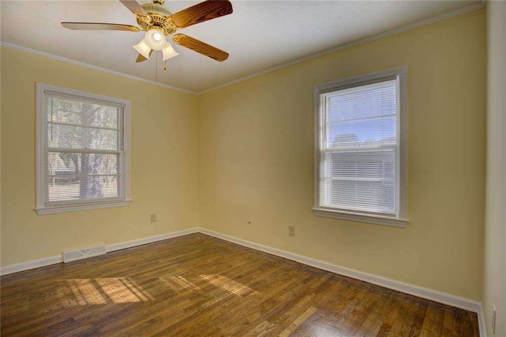 9174 Flat Shoals Road Southwest Covington, GA 30014 - Photo 20 of 25 a view of an empty room with wooden floor and a window