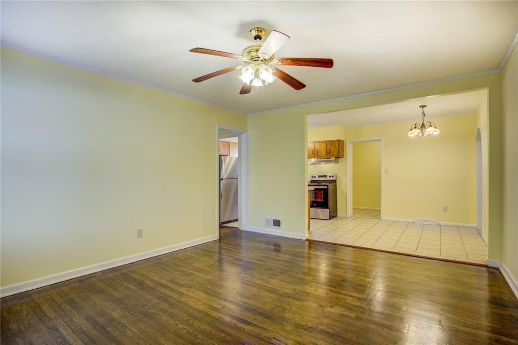 9174 Flat Shoals Road Southwest Covington, GA 30014 - Photo 2 of 25 wooden floor in an empty room with a window