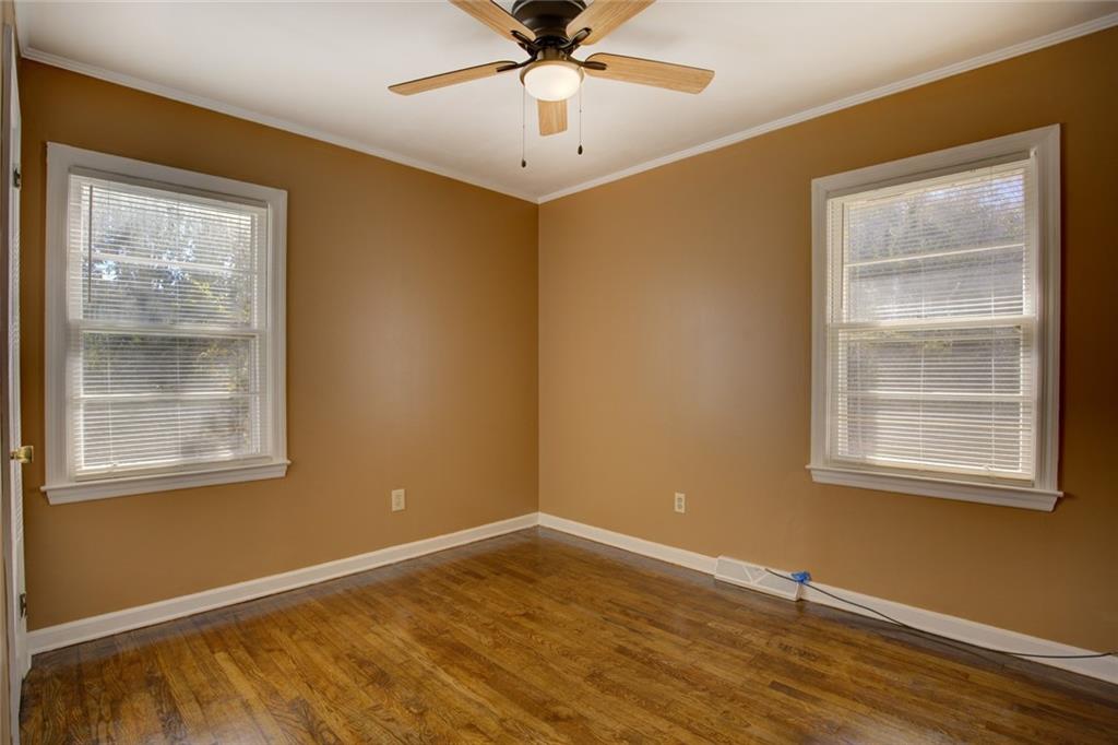 9174 Flat Shoals Road Southwest Covington, GA 30014 - Photo 21 of 25 a view of an empty room with wooden floor and a window