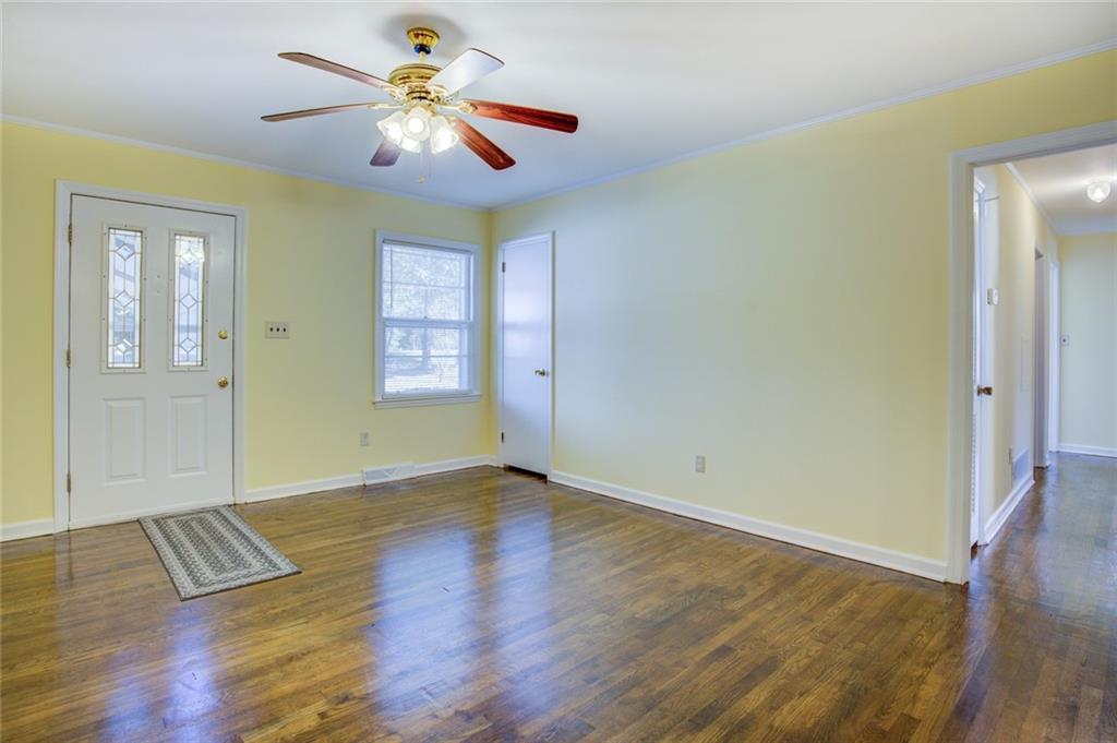 9174 Flat Shoals Road Southwest Covington, GA 30014 - Photo 3 of 25 a view of an empty room with window and wooden floor