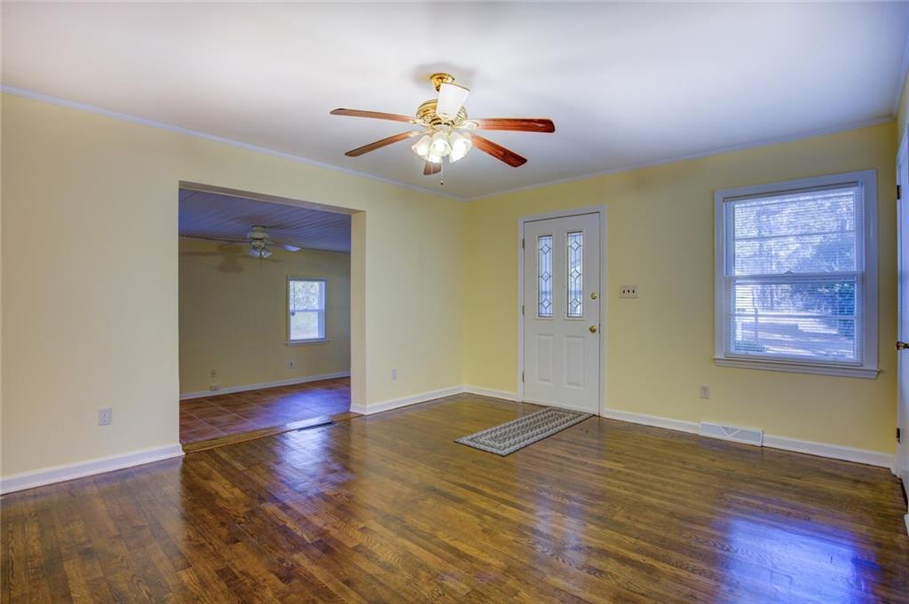 9174 Flat Shoals Road Southwest Covington, GA 30014 - Photo 5 of 25 a view of an empty room with window and wooden floor