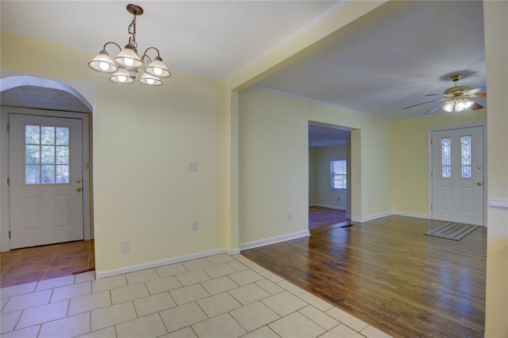 9174 Flat Shoals Road Southwest Covington, GA 30014 - Photo 10 of 25 wooden floor in an empty room with a mirror
