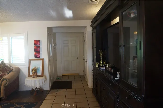 a hallway with kids room bathroom