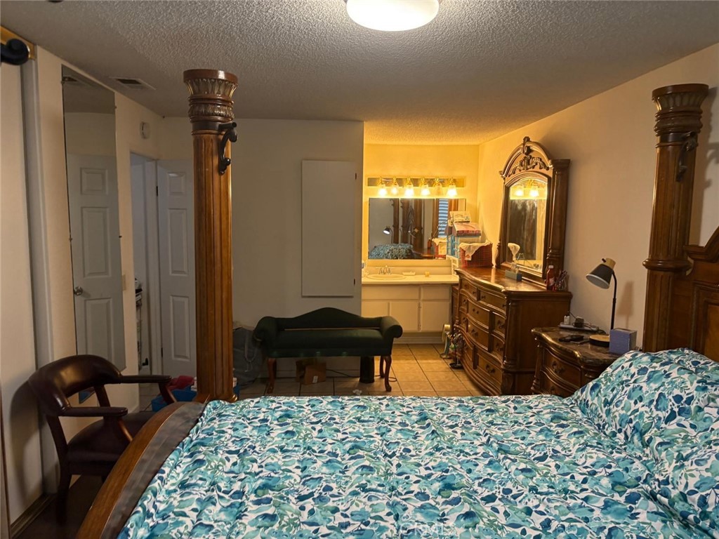 9442 Placer Street Rancho Cucamonga, CA 91730 - Photo 17 of 40 a bedroom with a bed and wooden floor