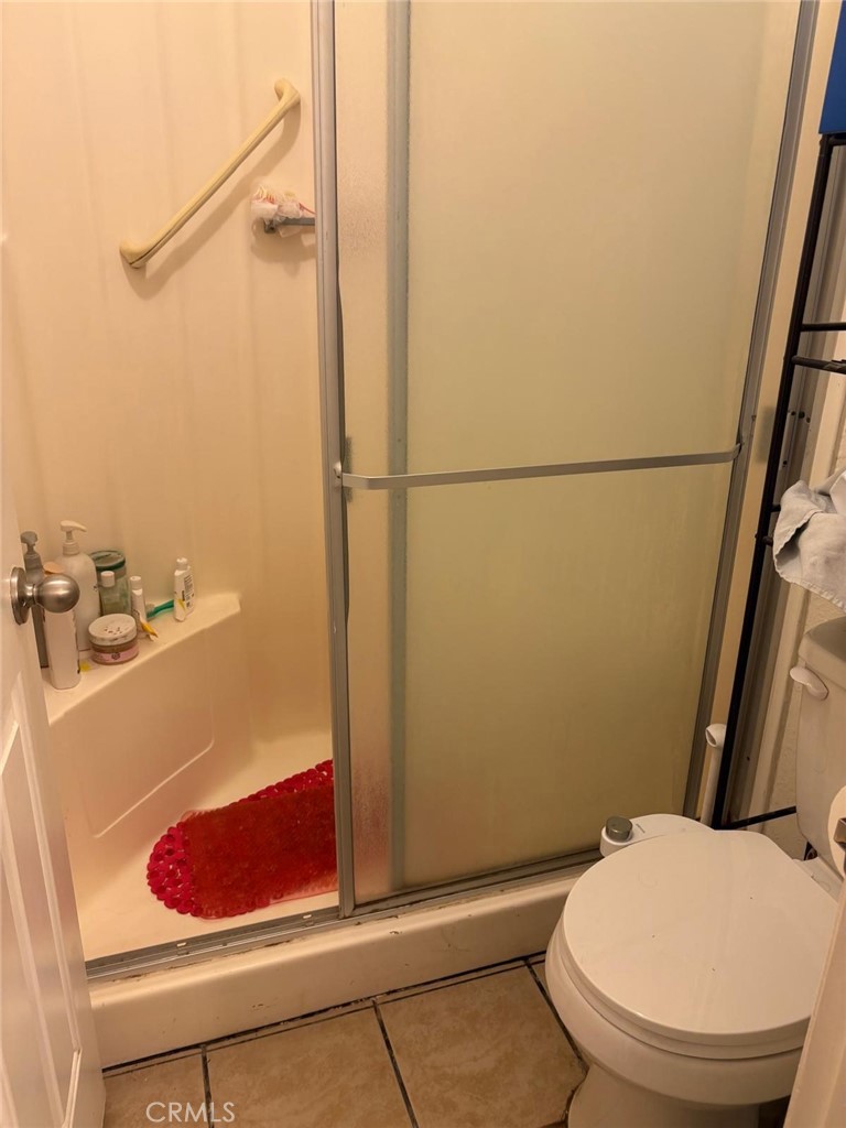 9442 Placer Street Rancho Cucamonga, CA 91730 - Photo 21 of 40 a bathroom with a toilet and a shower