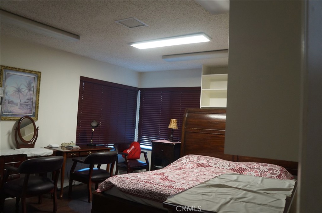 9442 Placer Street Rancho Cucamonga, CA 91730 - Photo 26 of 40 a bedroom with a bed and a desk