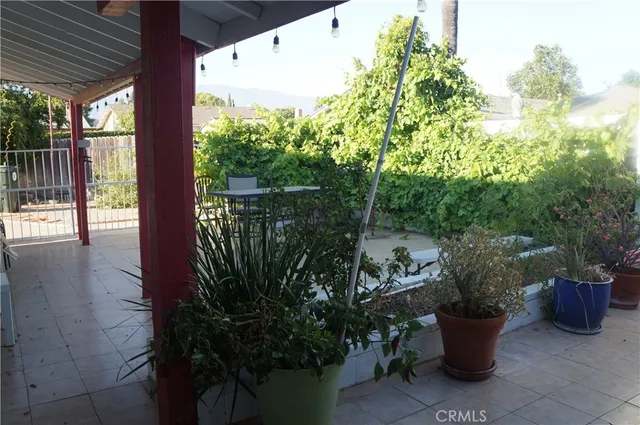 a view of a balcony with chair and potted plants