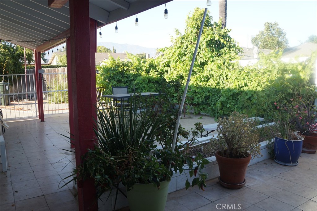 9442 Placer Street Rancho Cucamonga, CA 91730 - Photo 34 of 40 a view of a balcony with chair and potted plants