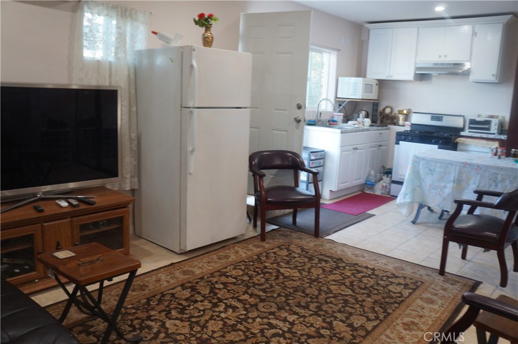 9442 Placer Street Rancho Cucamonga, CA 91730 - Photo 37 of 40 a kitchen with a dining table and chairs