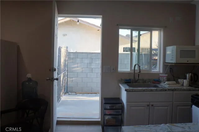 a bathroom with a granite countertop sink a mirror and shower