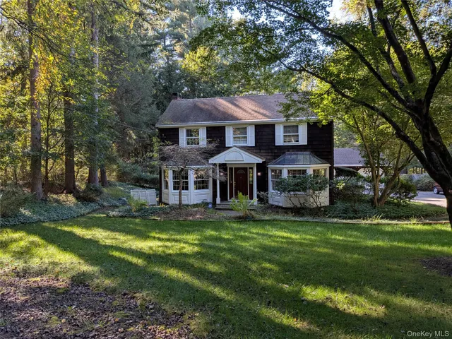 a view of a house with a yard balcony and swimming pool