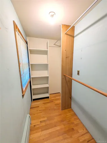 a view of walk in closet with empty racks