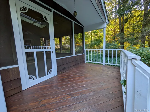 a view of balcony with wooden floor