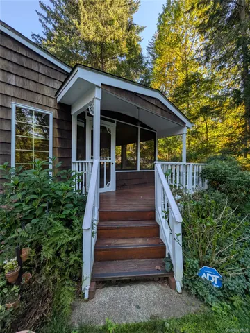 a view of a chairs and table in the backyard