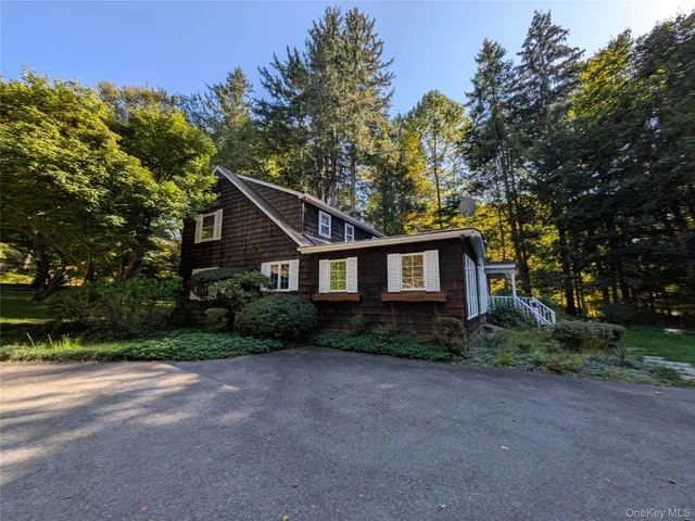 a house that has a tree in front of a house