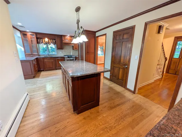 a kitchen with stainless steel appliances granite countertop a refrigerator a sink and a stove