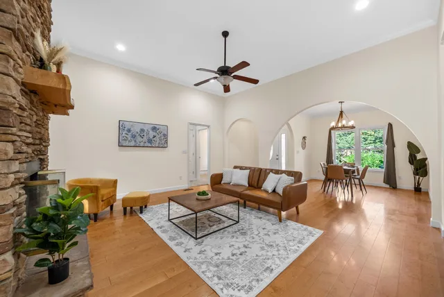 a living room with furniture and a chandelier