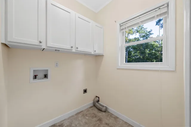 a room with kitchen island granite countertop wooden cabinets and stainless steel appliances