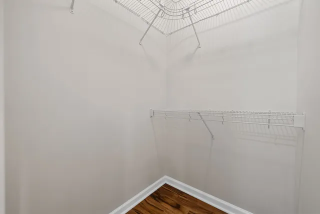 a view of an empty room with a ceiling fan