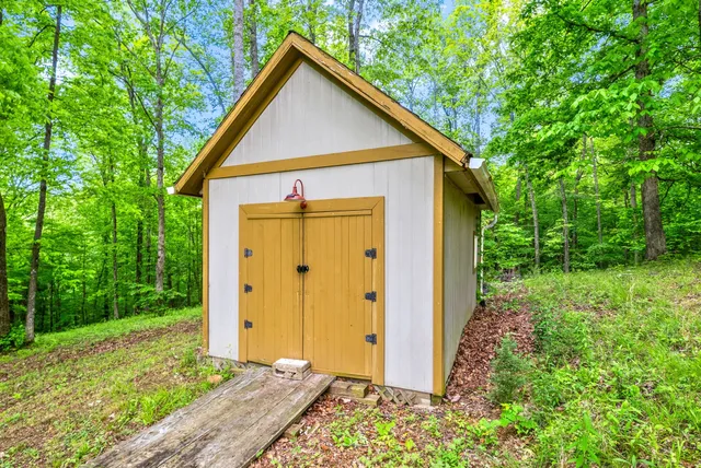 a front view of a house with a yard and trees