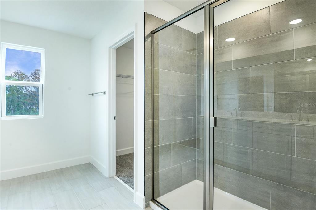 158 Waterstone Loop Tavares, FL 32778 - Photo 13 of 20 a bathroom that has a glass shower door