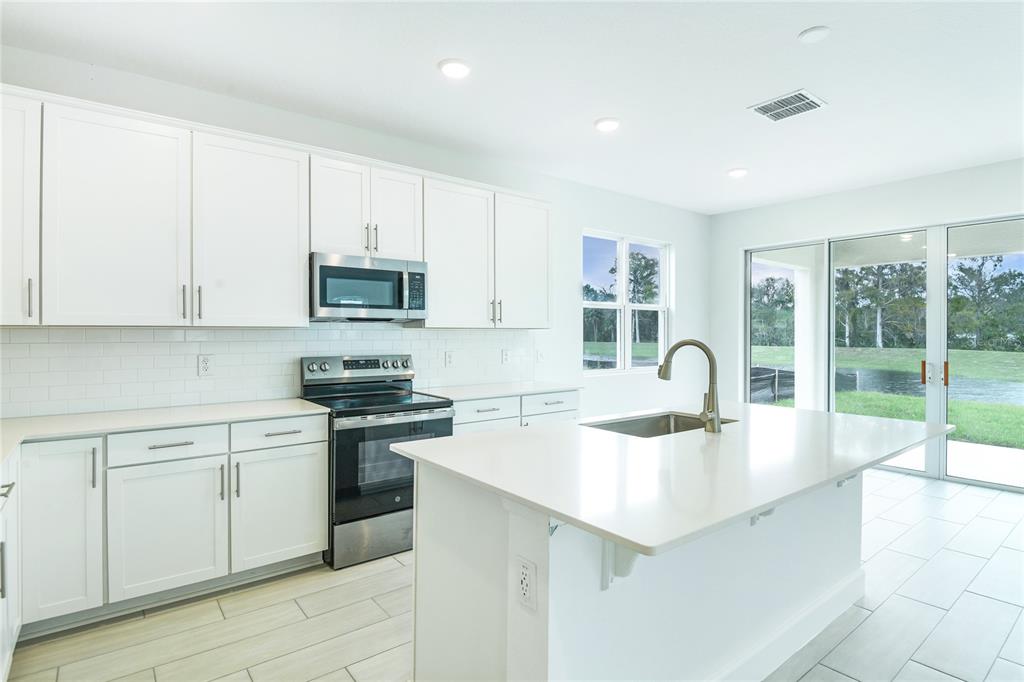 158 Waterstone Loop Tavares, FL 32778 - Photo 5 of 20 a kitchen with a sink stove and cabinets