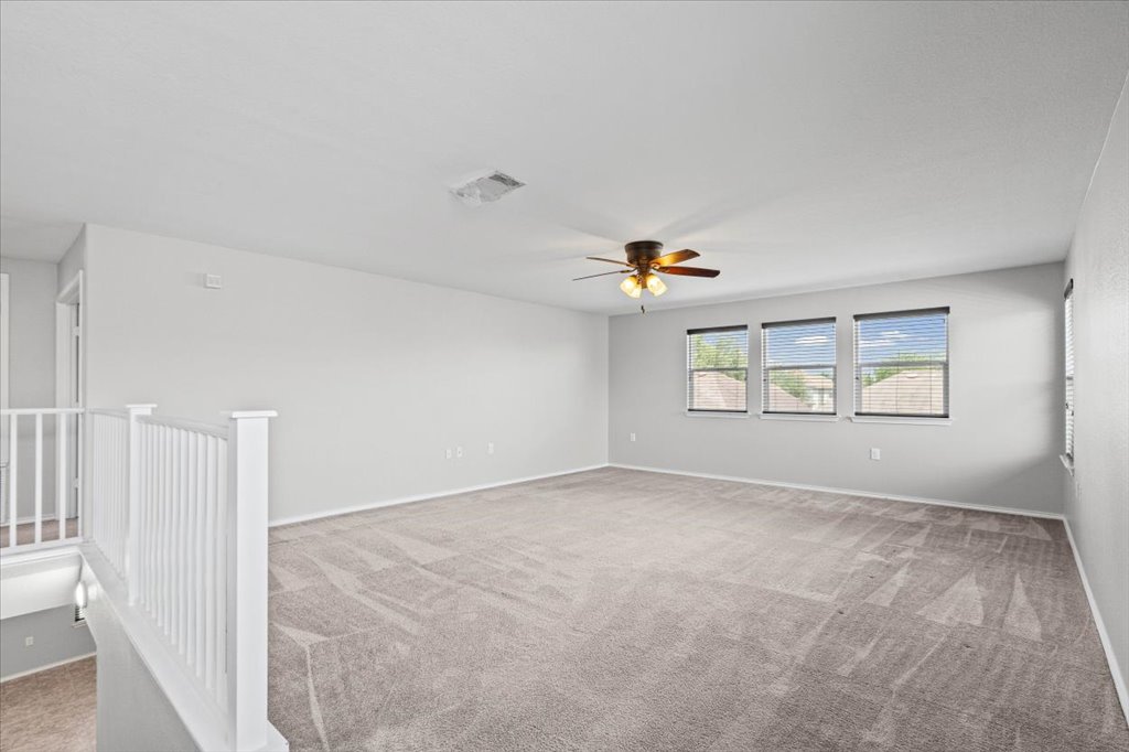 8804 Capitol View Drive Austin, TX 78747 - Photo 20 of 32 an empty room with windows and ceiling fan