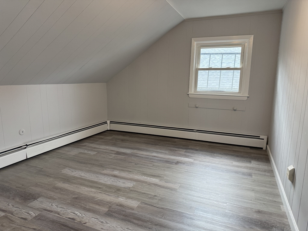 148 Maxfield Street, Unit 3 New Bedford, MA 02740 - Photo 13 of 21 an empty room with wooden floor and windows