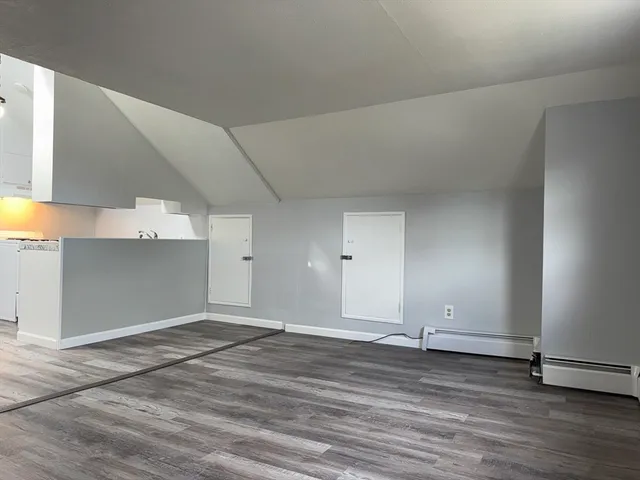 a view of a room with wooden floor