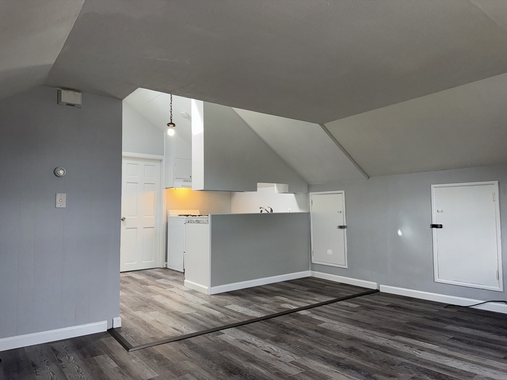 148 Maxfield Street, Unit 3 New Bedford, MA 02740 - Photo 6 of 21 a view of a room with wooden floor and cabinet
