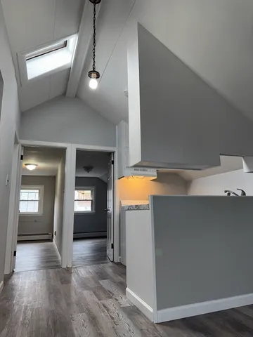 a view of a hallway with wooden floor