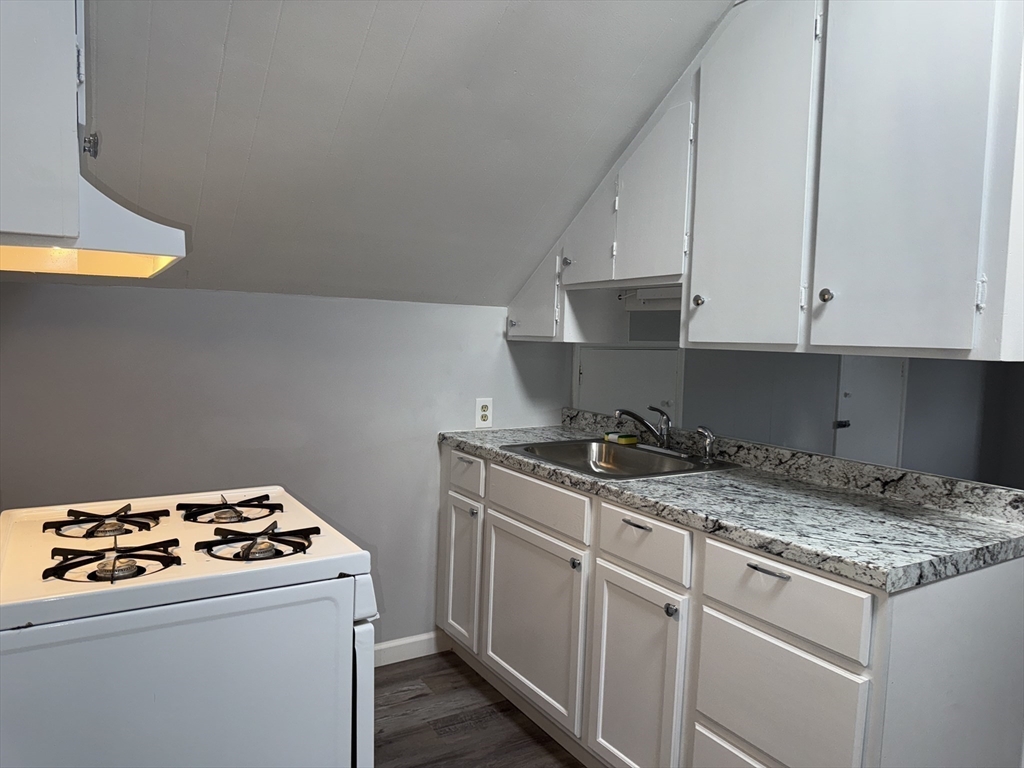 148 Maxfield Street, Unit 3 New Bedford, MA 02740 - Photo 8 of 21 a kitchen with a stove and a refrigerator