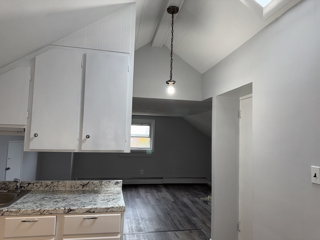 148 Maxfield Street, Unit 3 New Bedford, MA 02740 - Photo 10 of 21 a kitchen with kitchen island granite countertop refrigerator and stove