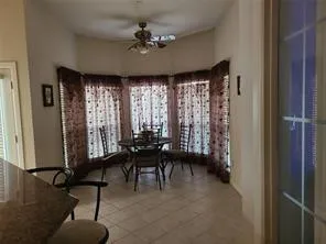 a workspace with hardwood floor and windows