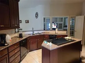 a kitchen with a sink stove and cabinets