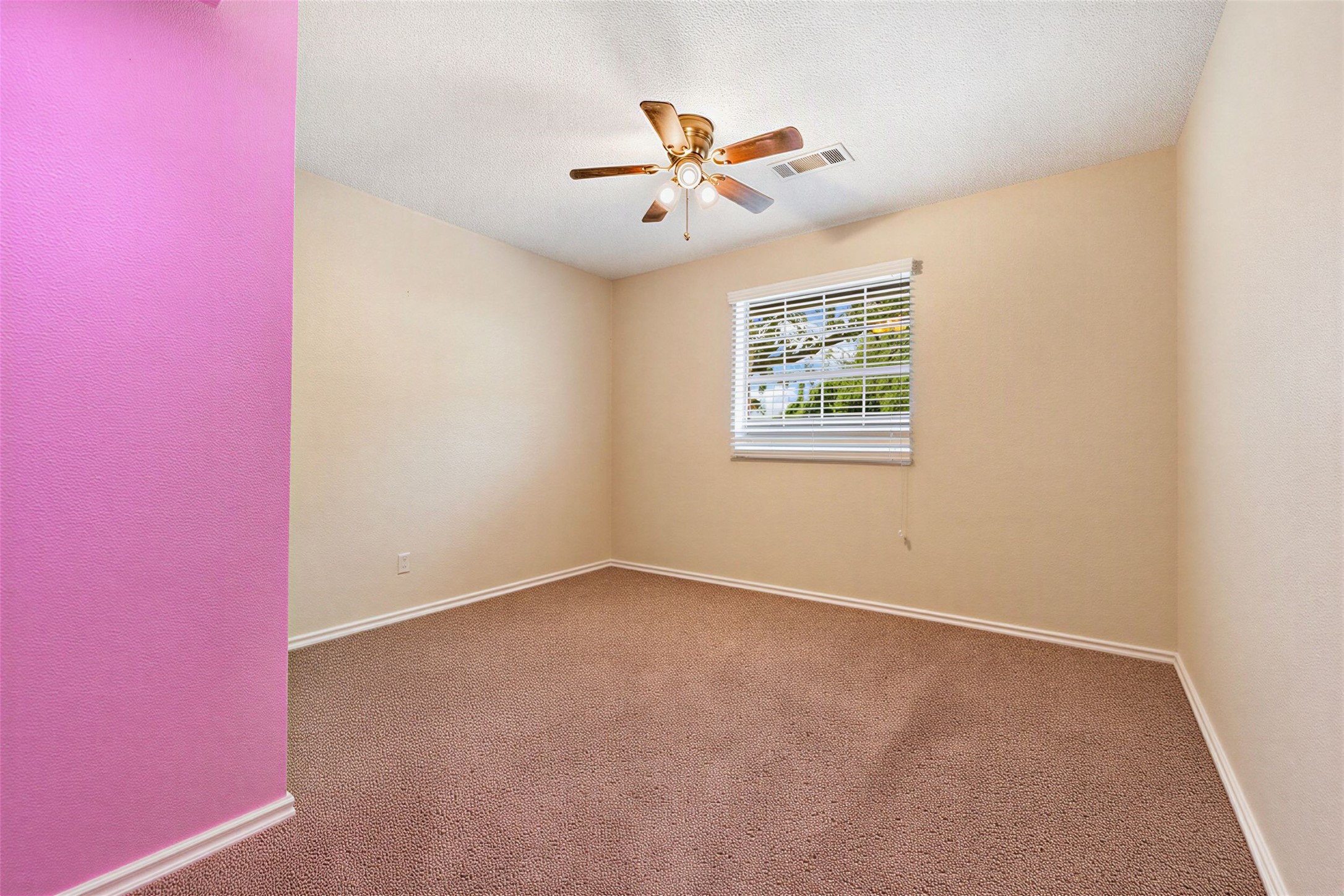 358 Easley Road Smithville, TX 78957 - Photo 28 of 36 Bedroom #3 featuring a large window, warm neutral walls, a ceiling fan and comfortable carpet flooring.