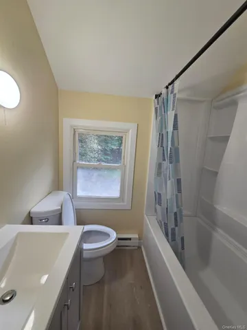 a bathroom with a sink a toilet and a bathtub