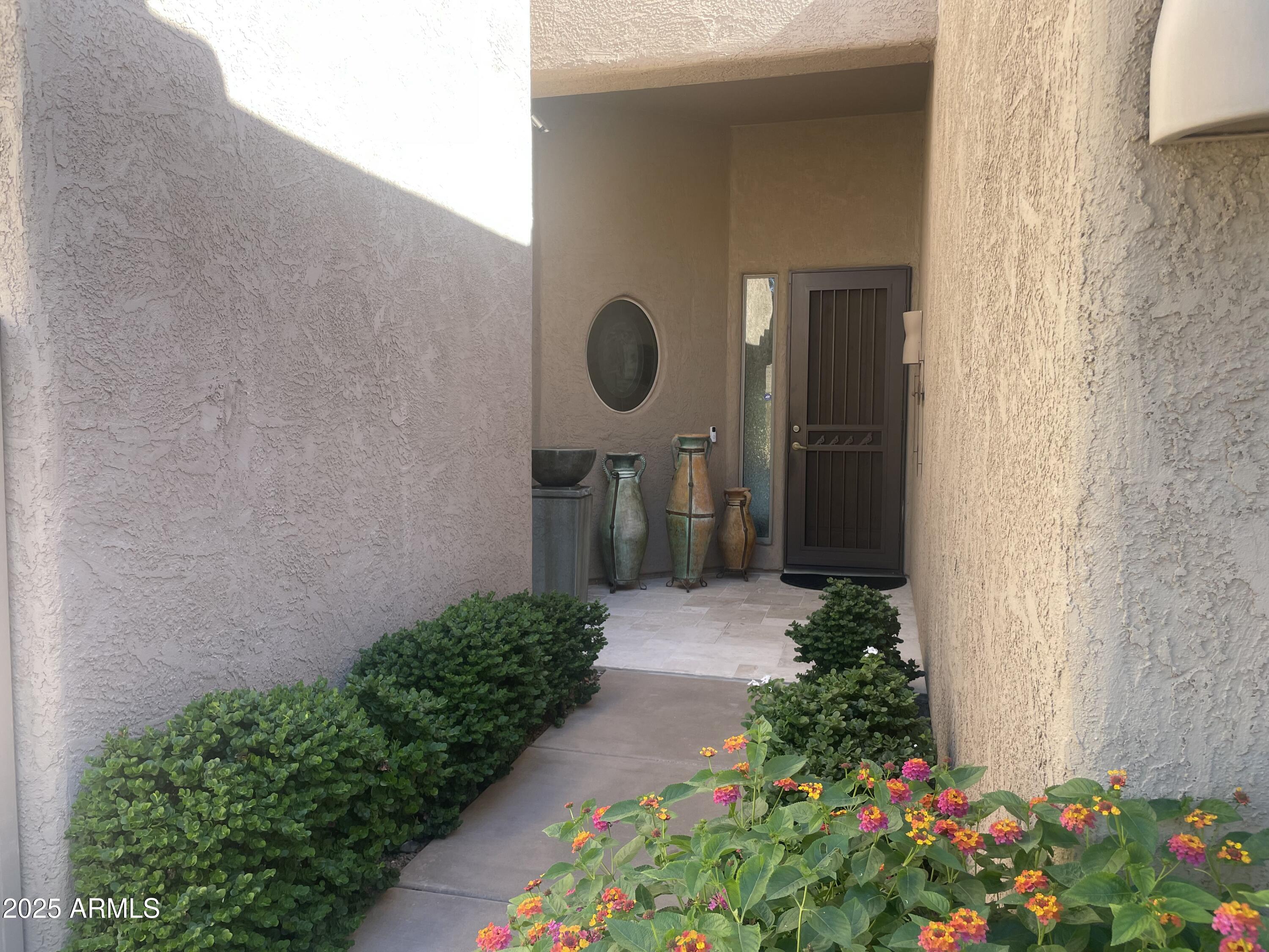 27723 North Quail Spring Road Rio Verde, AZ 85263 - Photo 2 of 3 a backyard of a house with flowers