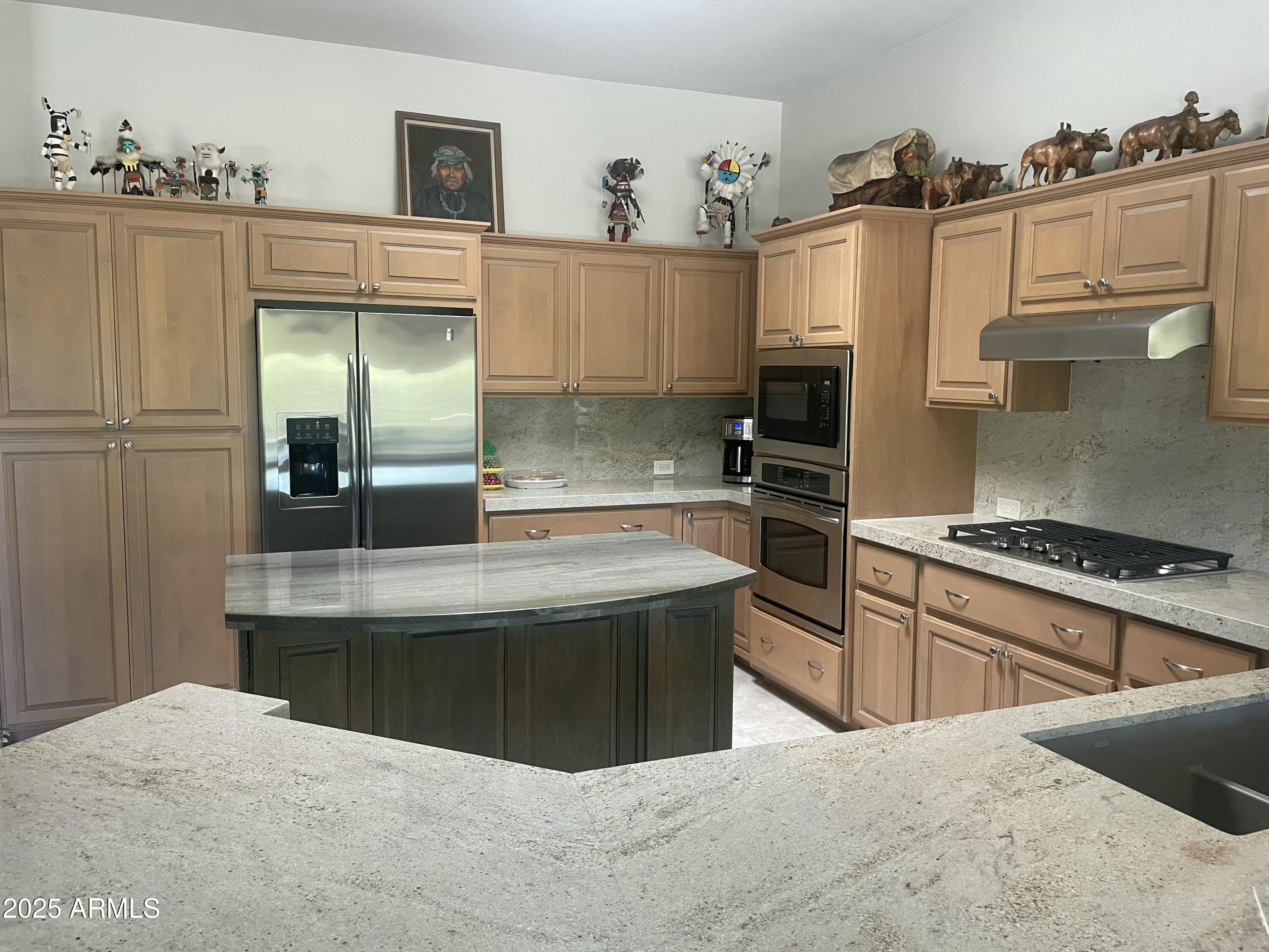 27723 North Quail Spring Road Rio Verde, AZ 85263 - Photo 3 of 3 a kitchen with stainless steel appliances granite countertop a stove and a refrigerator