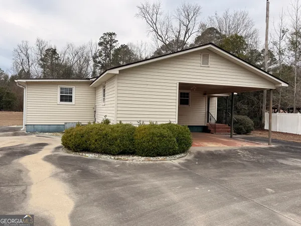 a view of a house with a yard and garage