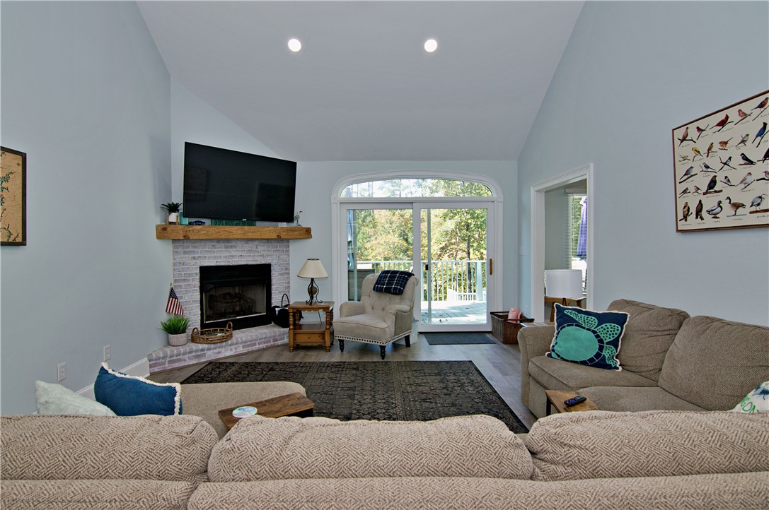206 Petty Road Seneca, SC 29672 - Photo 8 of 49 A brick fireplace anchors this inviting living space beneath a soaring vaulted ceiling.
