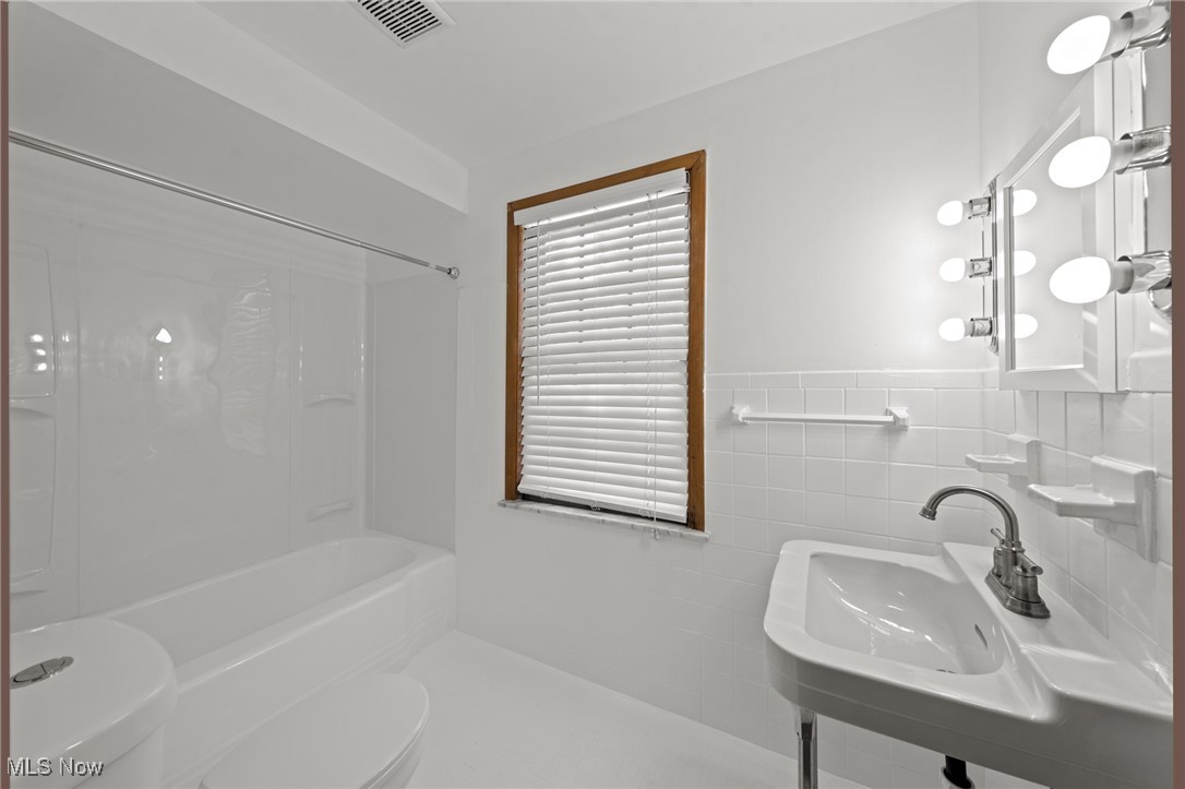 3686 Riedham Road Cleveland, OH 44120 - Photo 24 of 50 Full bathroom featuring sink, shower / bath combination, tile walls, and toilet