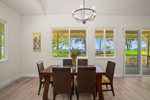 a view of a dining room with furniture wooden floor and chandelier