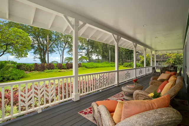 a balcony with furniture and garden view