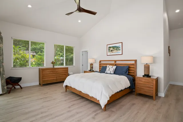 a bedroom with a bed and a large window